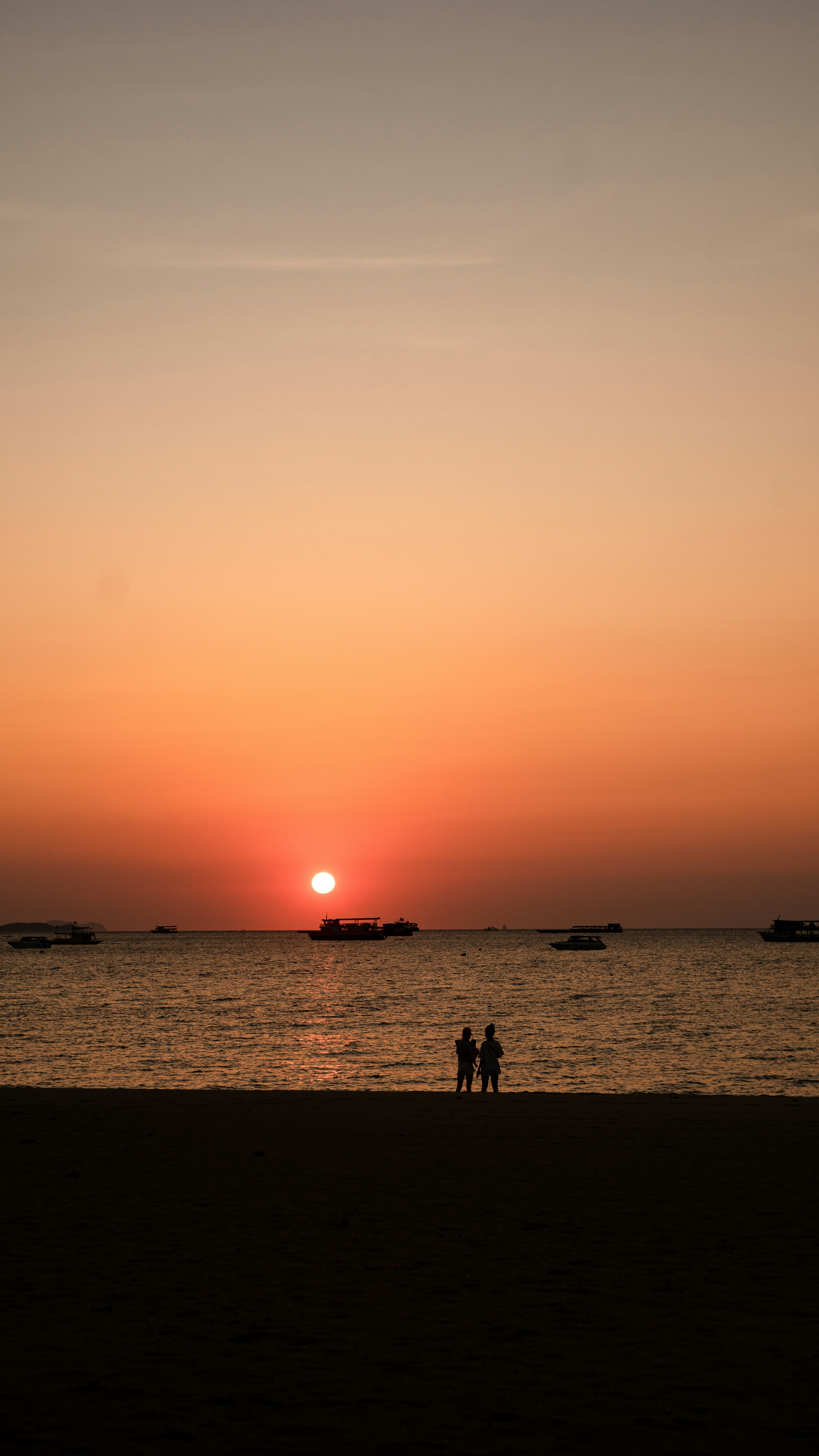 silhouette of people on beach during sunset